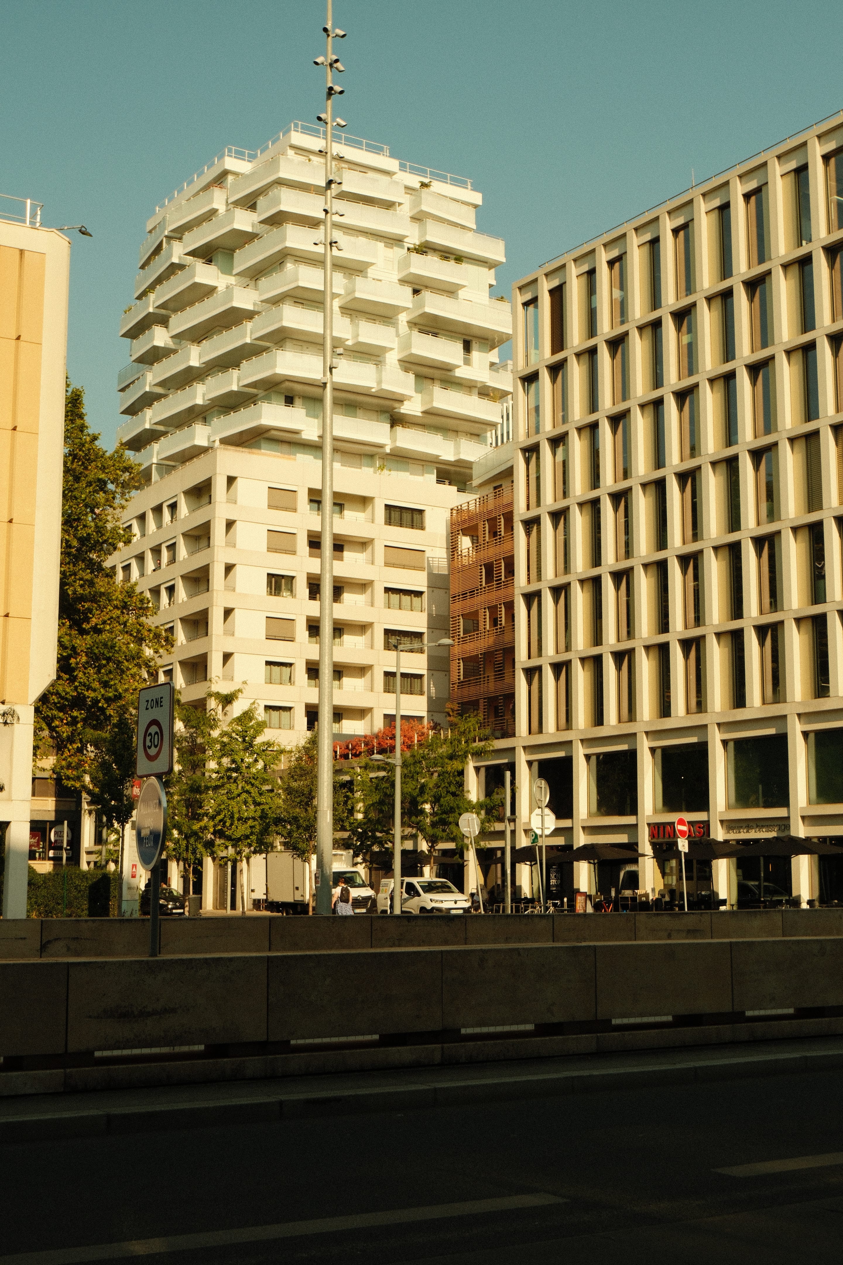 The stepped white building above the underpass.